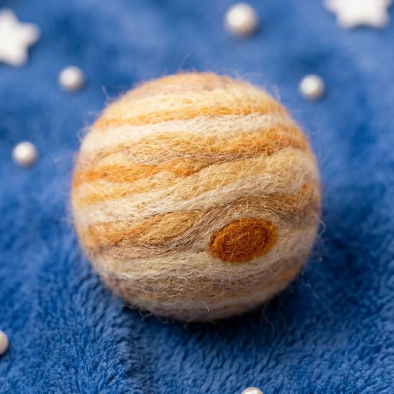 A needle-felted wool Jupiter with its storm bands